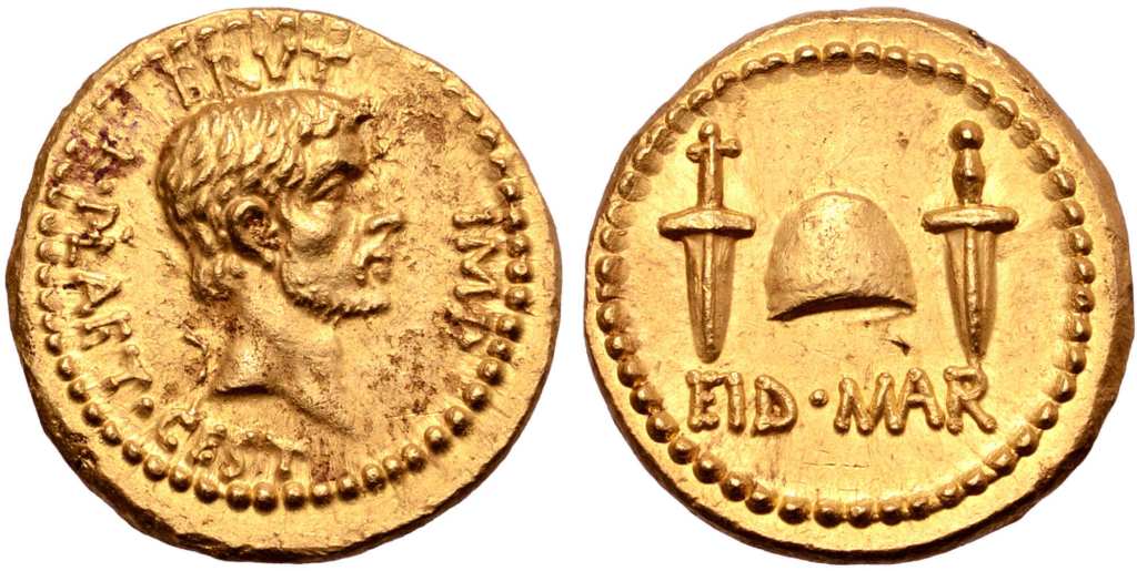 上图:主前42年秋天,布鲁图斯(Brutus)在腓立比即将战败之前发行的金币,庆祝元老院于主前44年3月15日三月节(Ides of March)刺杀凯撒。正面是自称「我爱凯撒,我更爱罗马」的布鲁图斯,背面写着「在三月节」的缩写EID MAR(Eidibus Martiis – on the Ides of March) ,中间是两把匕首之间的自由帽(Cap of Freedom)。自由帽是罗马奴隶被释放时传统戴着的帽子,但刀剑所带来的自由并没有长久,罗马共和国经过多年内战,于主前27年变成了专制独裁的罗马帝国。