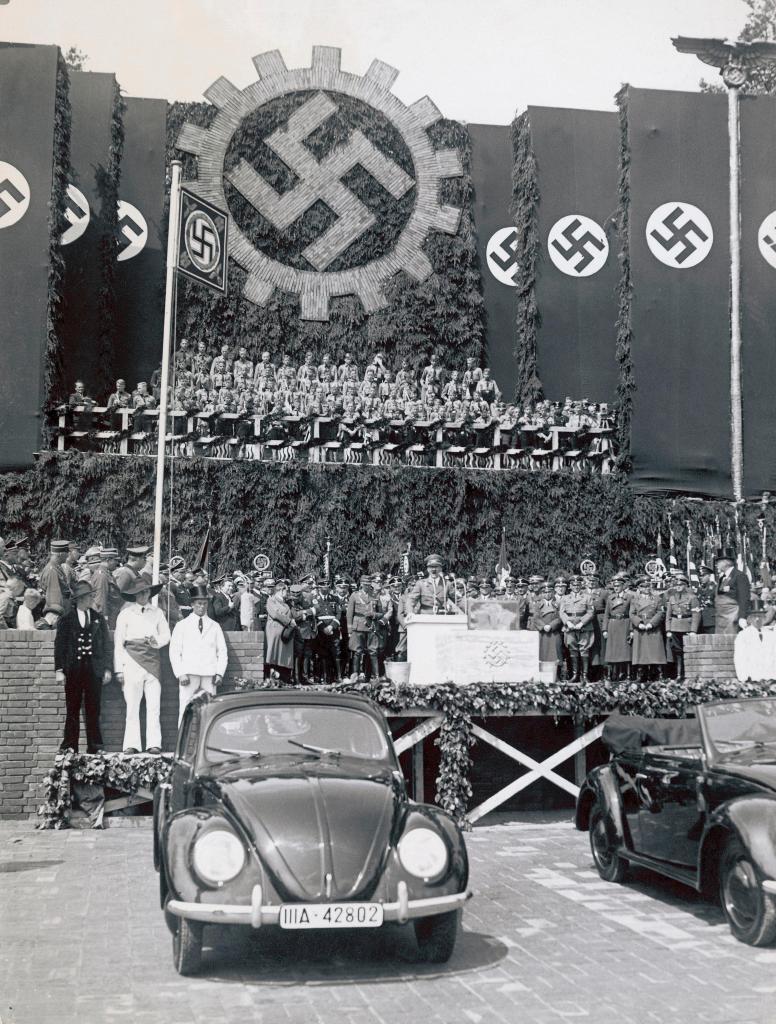 上图:1938年6月25日,希特勒在沃尔夫斯堡参加大众汽车厂的奠基仪式,前面是一辆大众甲壳虫汽车。希特勒上台后不久,就要求生产一种普通德国人买得起的「人民汽车」,可容纳2名成人和3名儿童、最高时速可达100km/h、最好采用风冷发动机,只卖990马克。奥地利工程师费迪南德·保时捷根据这一要求设计出著名的大众甲壳虫汽车。1936年10月12日,三辆大众VW-1下线。1938年,大众汽车公司在沃尔夫斯堡建厂,计划年产150万辆。二战期间,大众的生产能力被用于军备生产。德国人民所盼望的好处,最后都归于无有。正如圣经对大淫妇的预言:「你所看见的那十角与兽必恨这淫妇,使她冷落赤身,又要吃她的肉,用火将她烧尽」(启十七16)。兽其实并不喜欢大淫妇,只是暂时利用大淫妇迷惑世人。当大淫妇的价值被榨取干净之后,就会被付之一炬。